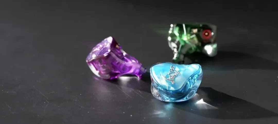 Three internally coloured earphone shells